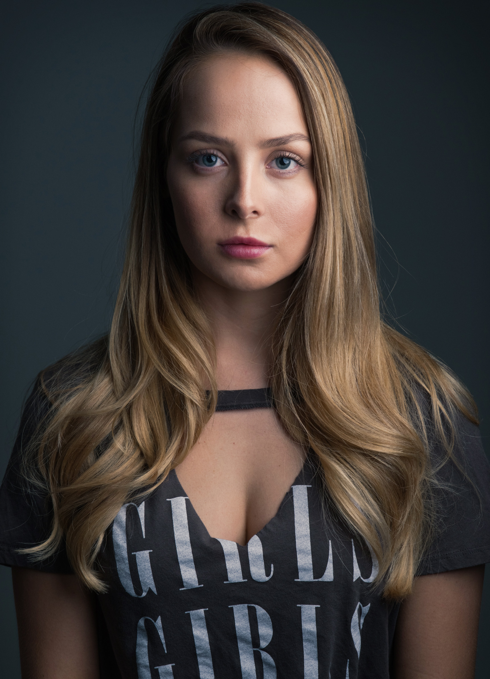 Woman wearing a choker and a graphic t-shirt, close-up portrait