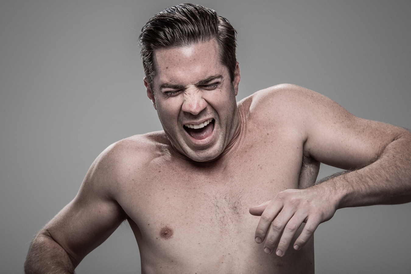 Studio headshot portrait 2 from the Stun Gun Photoshoot series, person gasping open-mouthed as they are hit with a stun gun