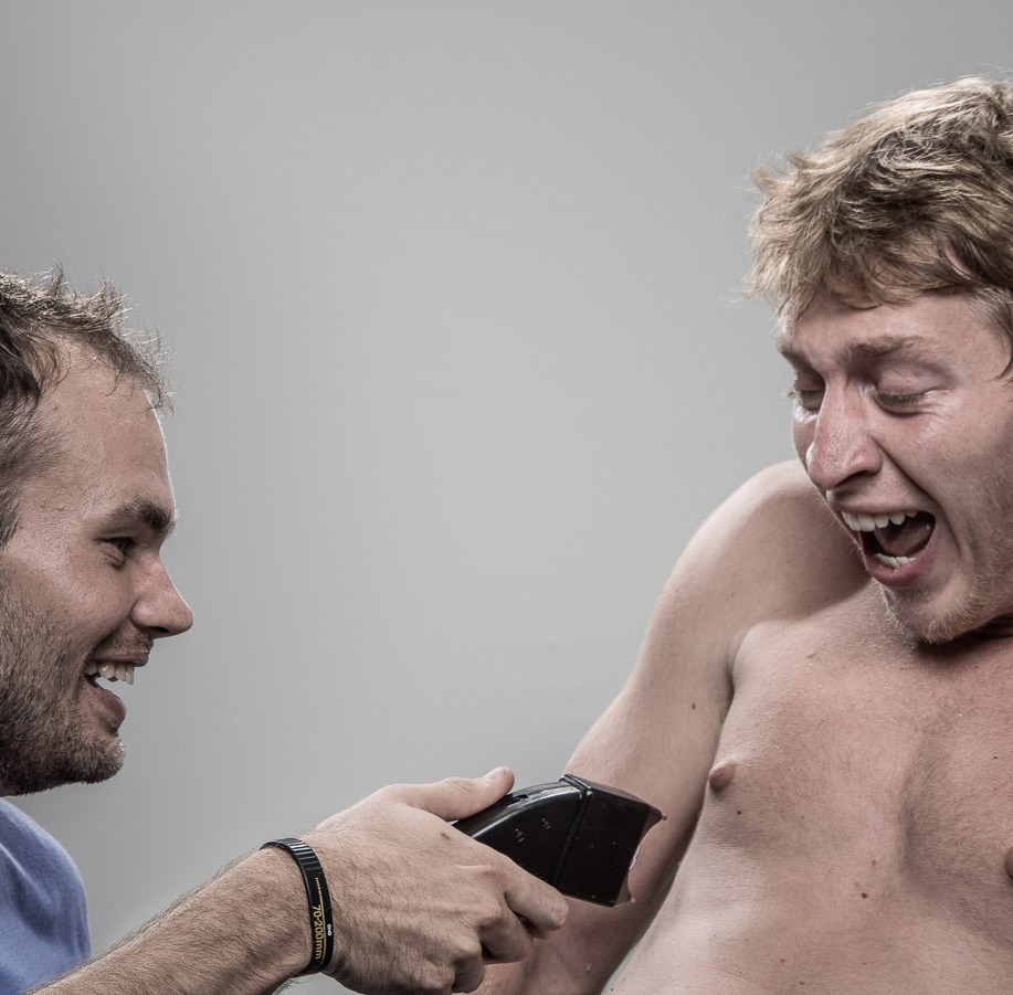 Studio headshot portrait 5 from the Stun Gun Photoshoot series, person recoiling with a startled laugh as they are hit with a stun gun