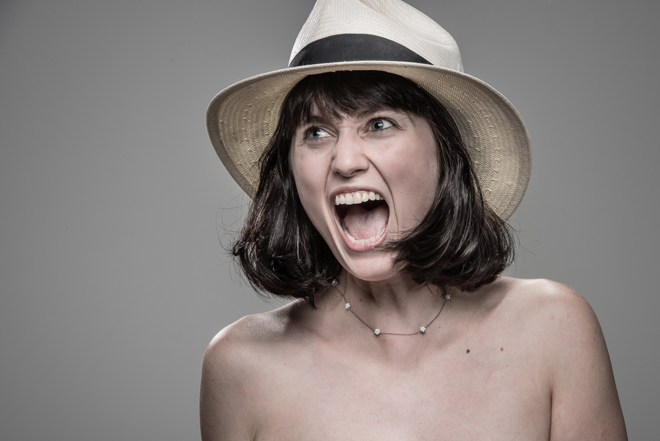 Studio headshot portrait 10 from the Stun Gun Photoshoot series, person crying out mid-shock as they are hit with a stun gun