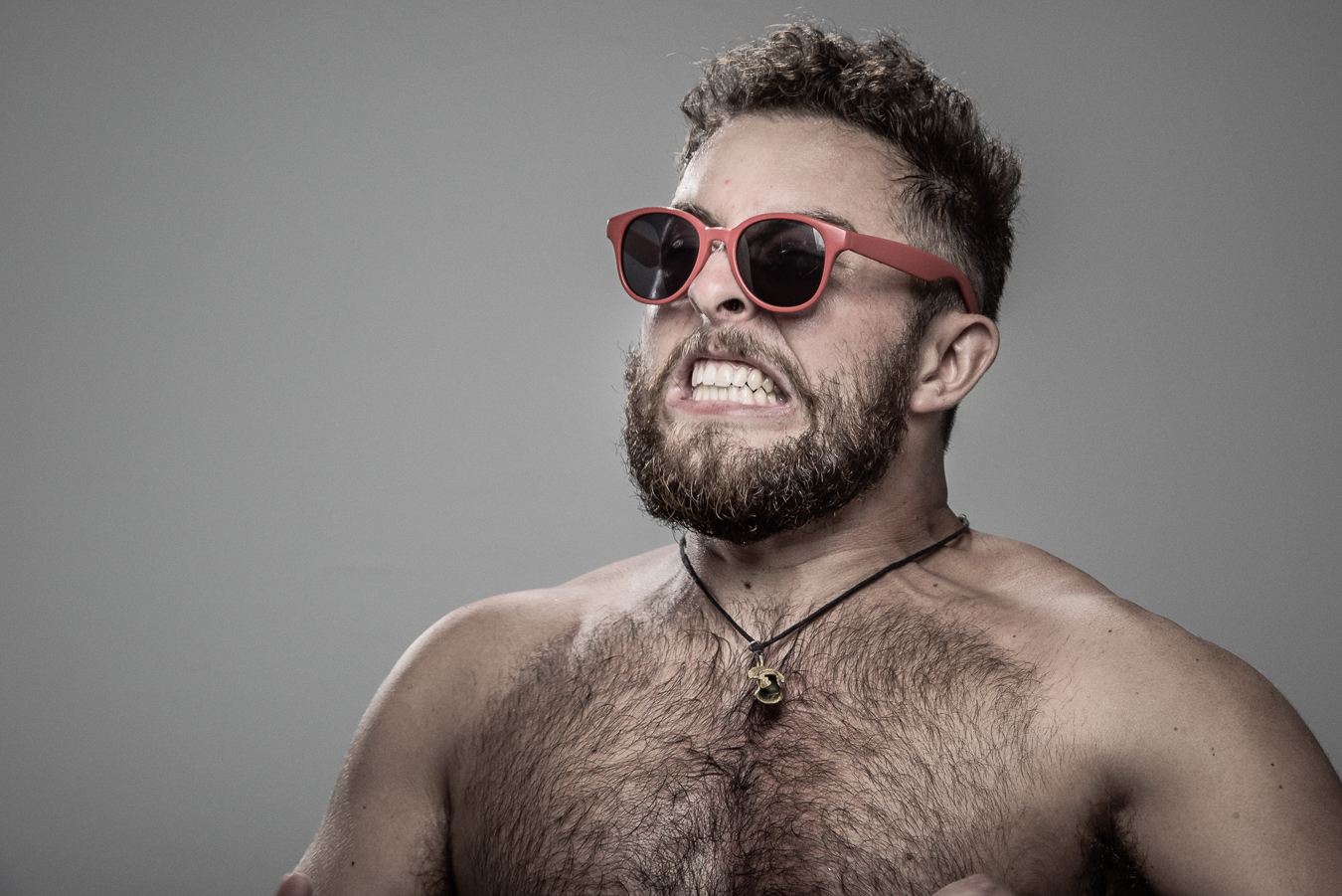 Studio headshot portrait 12 from the Stun Gun Photoshoot series, person grimacing with clenched teeth as they are hit with a stun gun