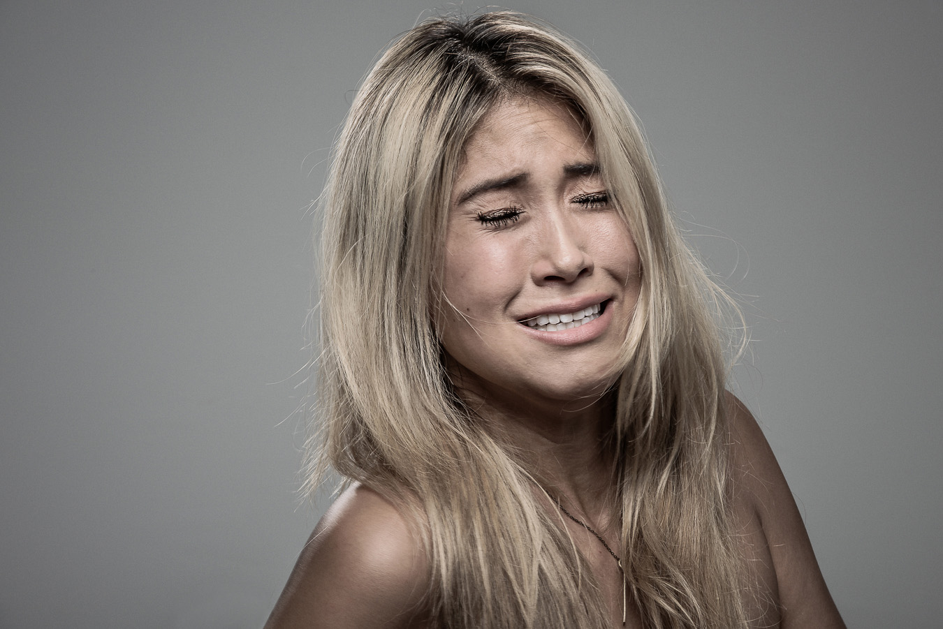 Studio headshot portrait 14 from the Stun Gun Photoshoot series, person gasping open-mouthed as they are hit with a stun gun