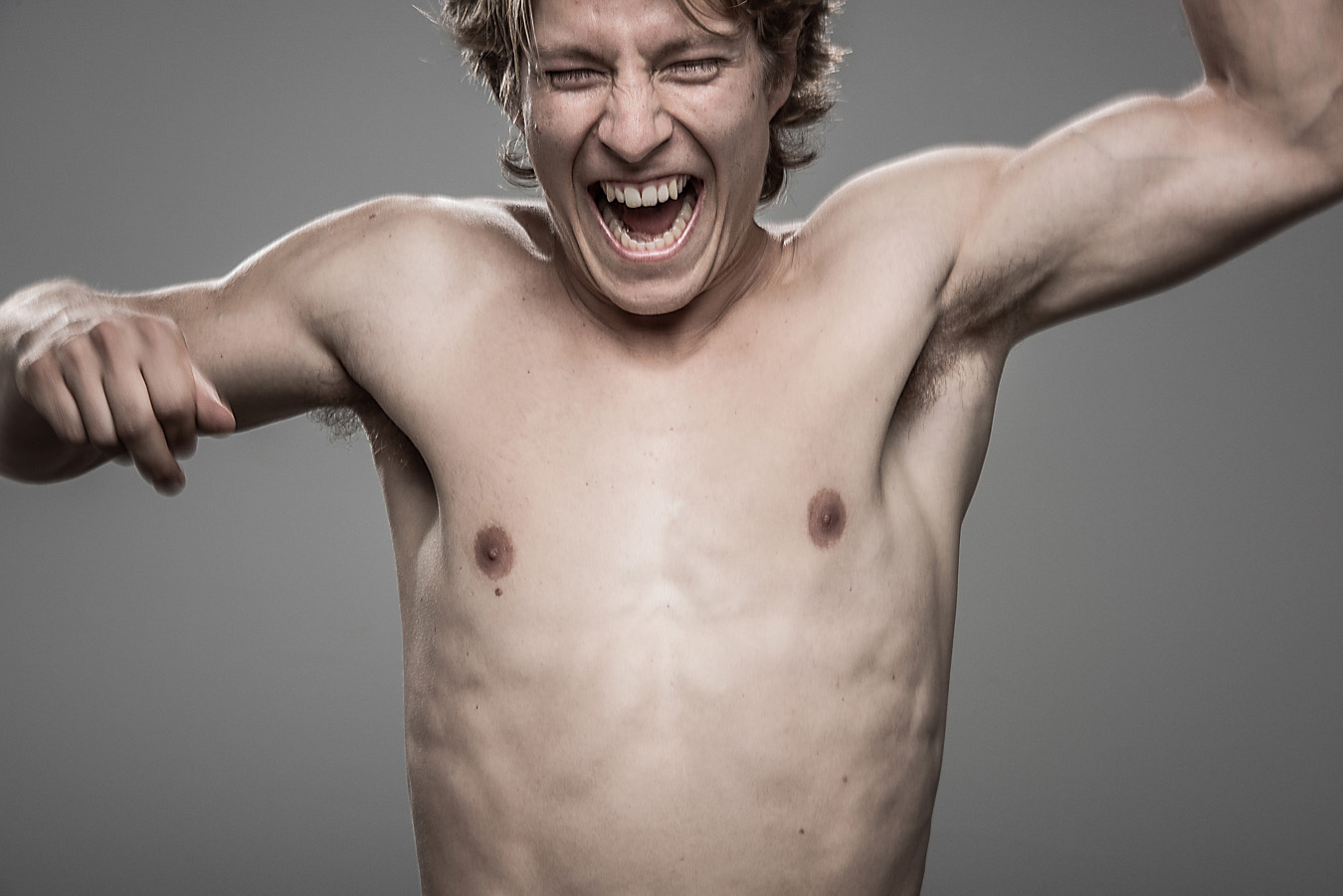 Studio headshot portrait 18 from the Stun Gun Photoshoot series, person grimacing with clenched teeth as they are hit with a stun gun