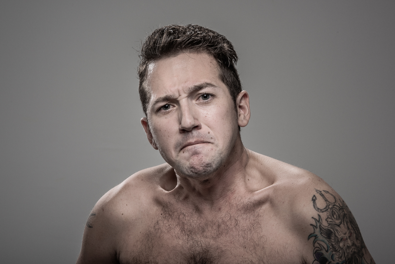 Studio headshot portrait 22 from the Stun Gun Photoshoot series, person crying out mid-shock as they are hit with a stun gun