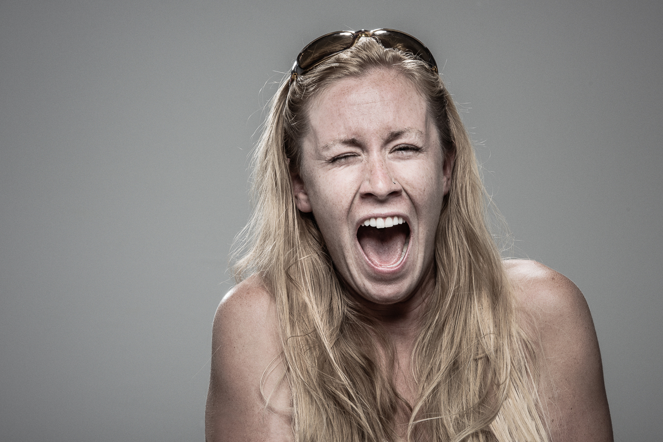 Studio headshot portrait 24 from the Stun Gun Photoshoot series, person grimacing with clenched teeth as they are hit with a stun gun