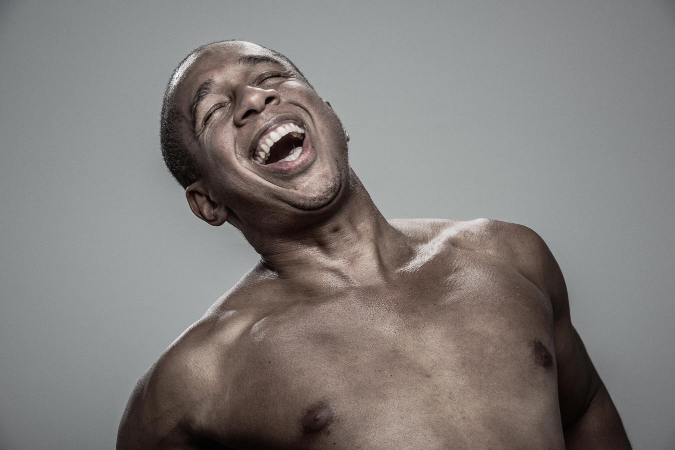 Studio headshot portrait 26 from the Stun Gun Photoshoot series, person gasping open-mouthed as they are hit with a stun gun