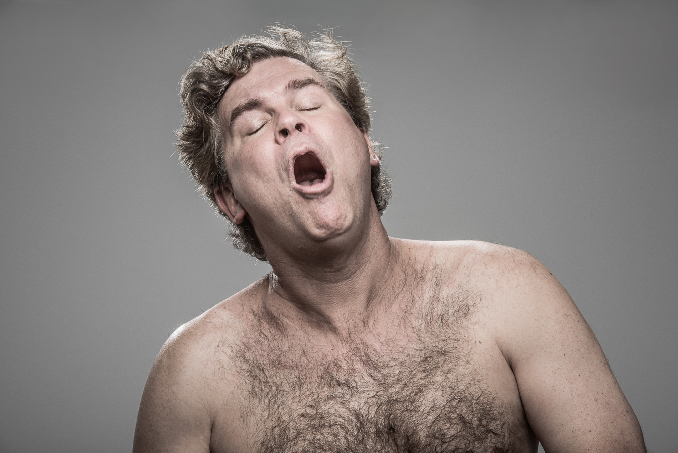 Studio headshot portrait 27 from the Stun Gun Photoshoot series, person flinching and grimacing as they are hit with a stun gun