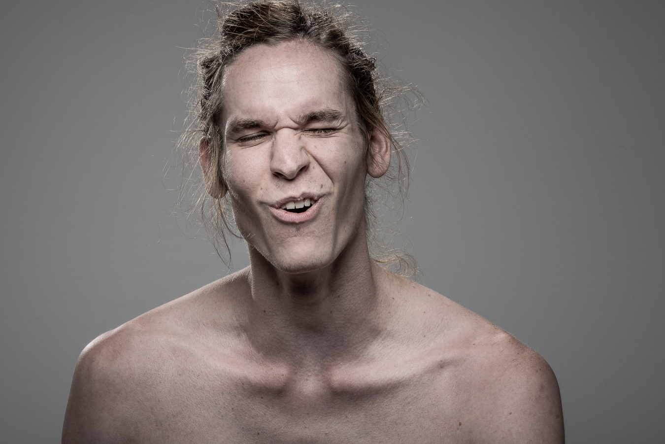 Studio headshot portrait 28 from the Stun Gun Photoshoot series, person crying out mid-shock as they are hit with a stun gun