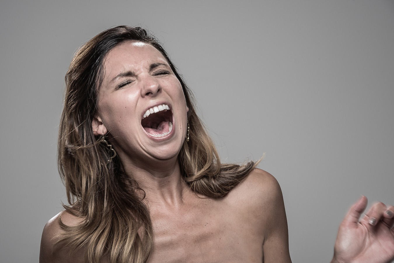 Studio headshot portrait 32 from the Stun Gun Photoshoot series, person gasping open-mouthed as they are hit with a stun gun