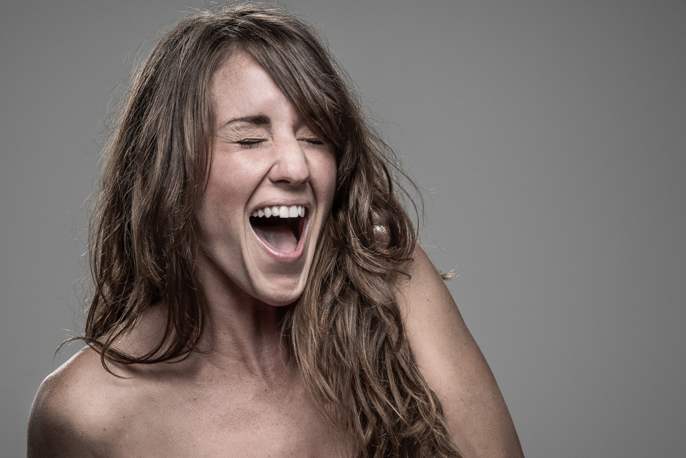 Studio headshot portrait 33 from the Stun Gun Photoshoot series, person flinching and grimacing as they are hit with a stun gun