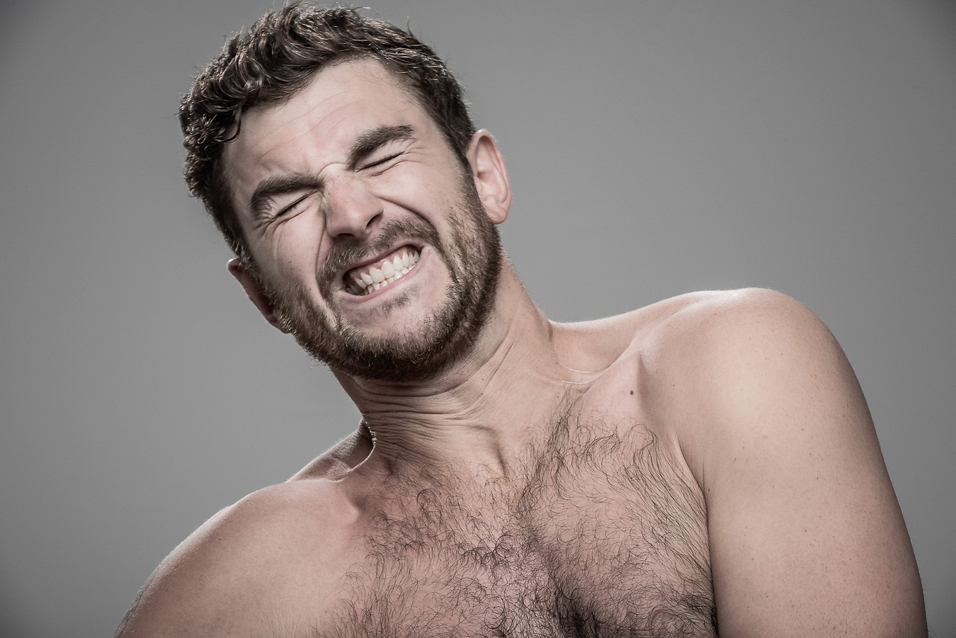 Studio headshot portrait 34 from the Stun Gun Photoshoot series, person crying out mid-shock as they are hit with a stun gun