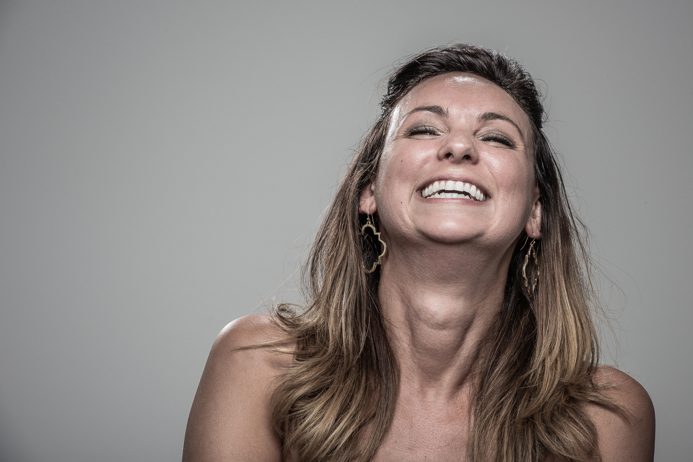 Studio headshot portrait 35 from the Stun Gun Photoshoot series, person recoiling with a startled laugh as they are hit with a stun gun