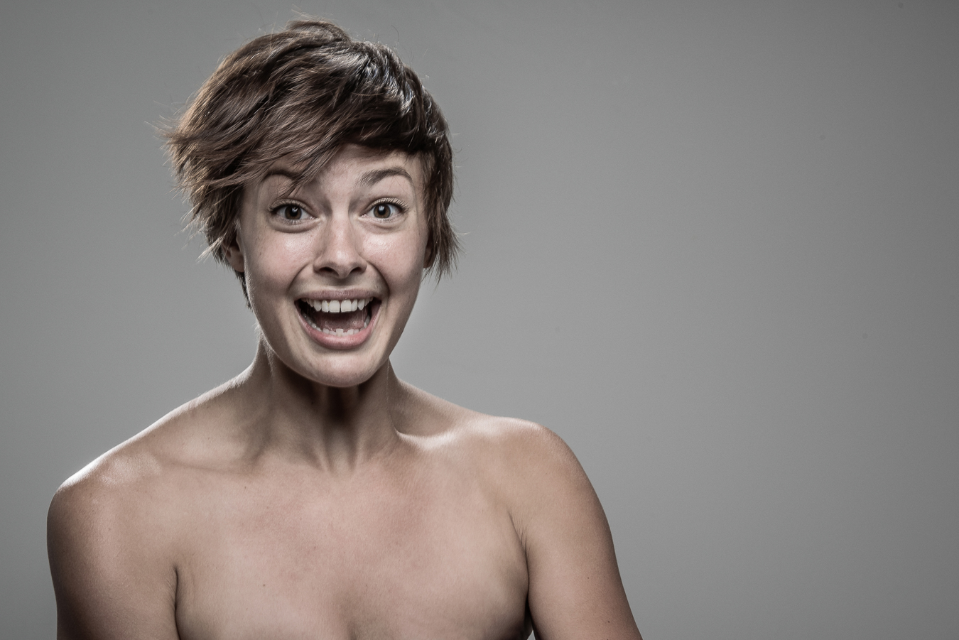 Studio headshot portrait 38 from the Stun Gun Photoshoot series, person gasping open-mouthed as they are hit with a stun gun
