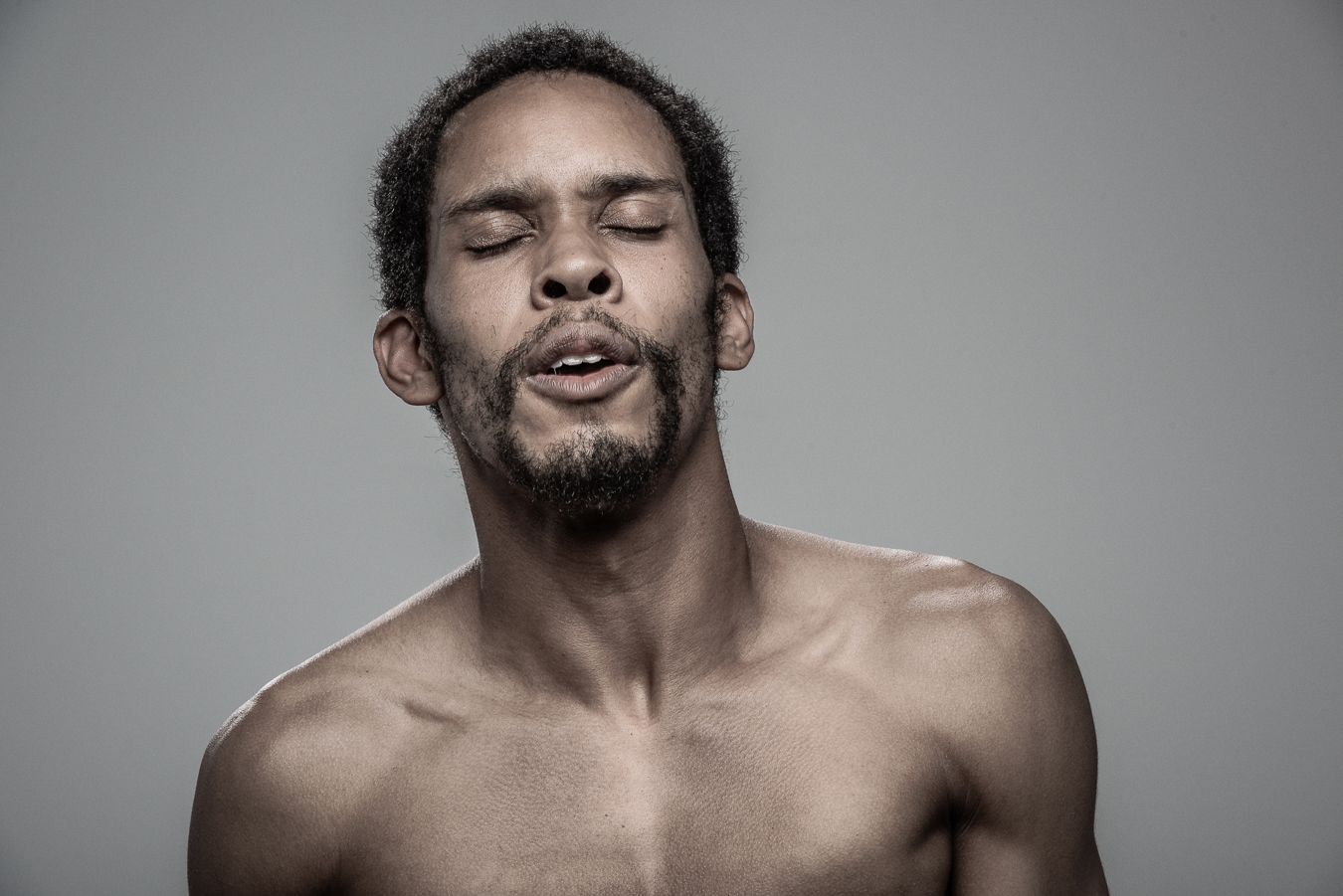 Studio headshot portrait 39 from the Stun Gun Photoshoot series, person flinching and grimacing as they are hit with a stun gun