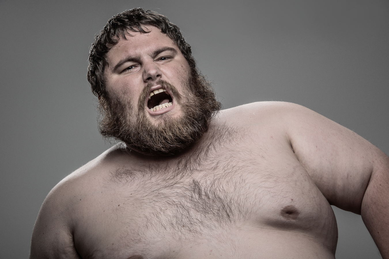 Studio headshot portrait 42 from the Stun Gun Photoshoot series, person grimacing with clenched teeth as they are hit with a stun gun