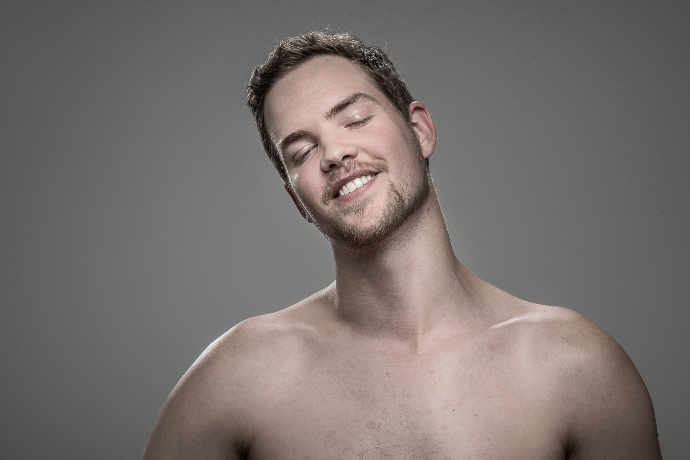 Studio headshot portrait 44 from the Stun Gun Photoshoot series, person gasping open-mouthed as they are hit with a stun gun