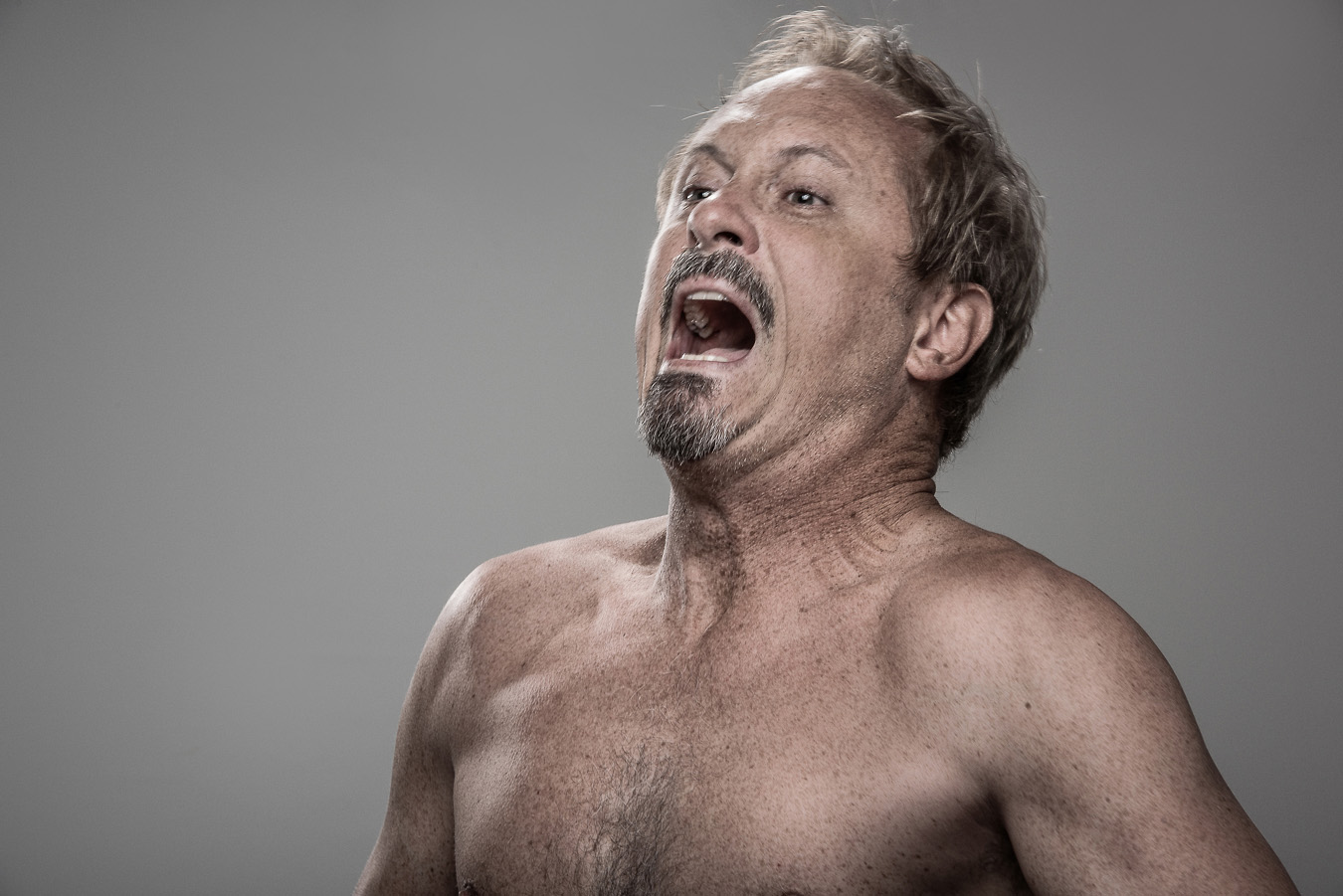 Studio headshot portrait 50 from the Stun Gun Photoshoot series, person gasping open-mouthed as they are hit with a stun gun
