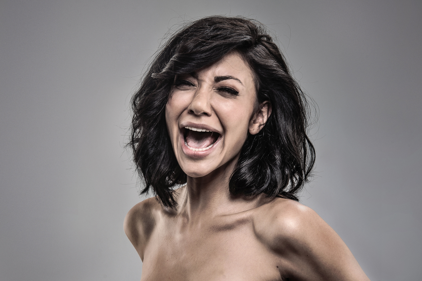 Studio headshot portrait 56 from the Stun Gun Photoshoot series, person gasping open-mouthed as they are hit with a stun gun