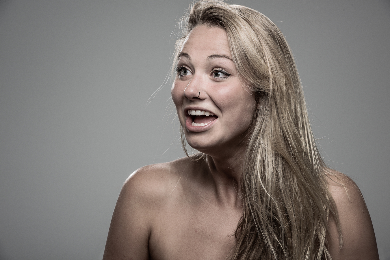 Studio headshot portrait 57 from the Stun Gun Photoshoot series, person flinching and grimacing as they are hit with a stun gun