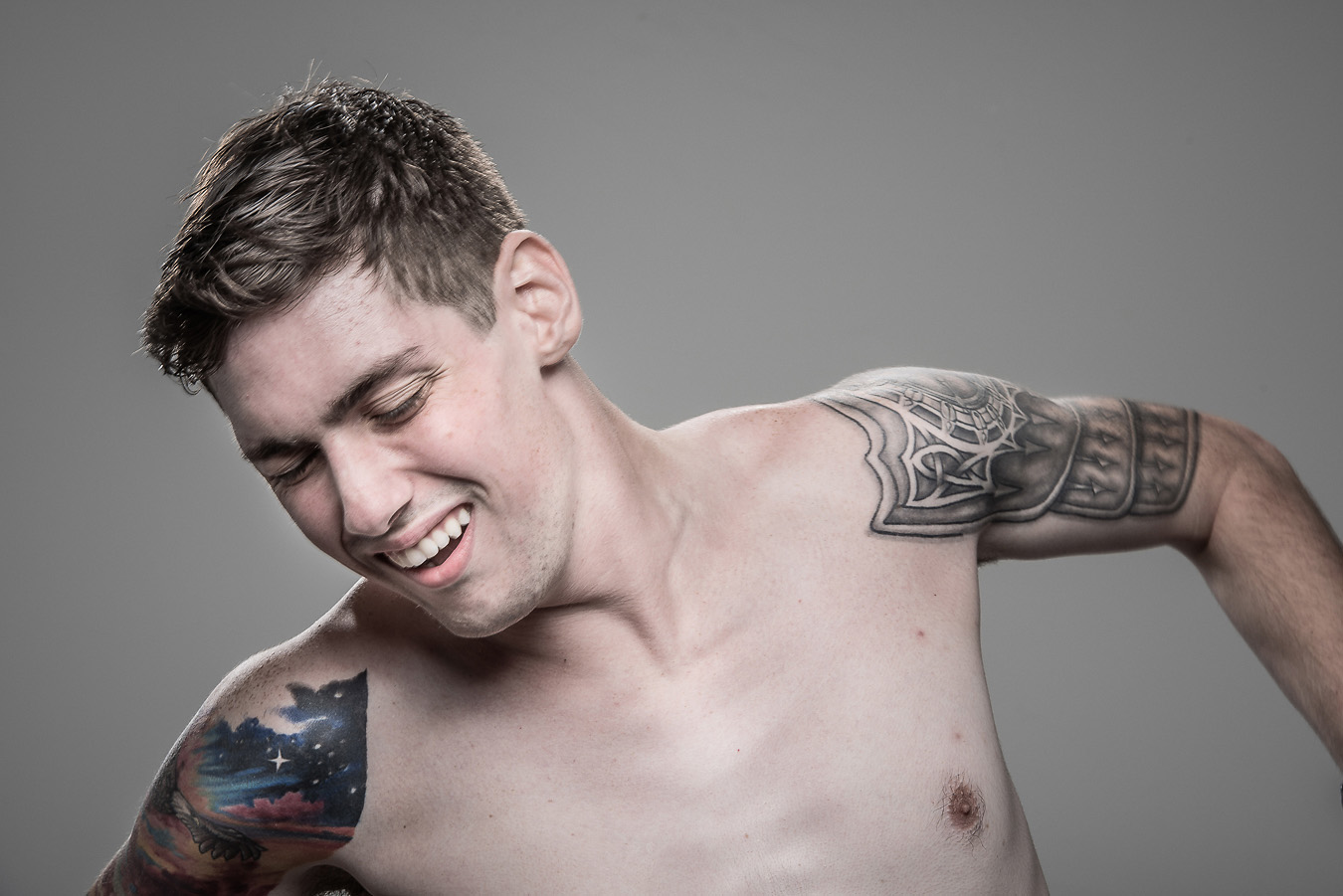 Studio headshot portrait 59 from the Stun Gun Photoshoot series, person recoiling with a startled laugh as they are hit with a stun gun